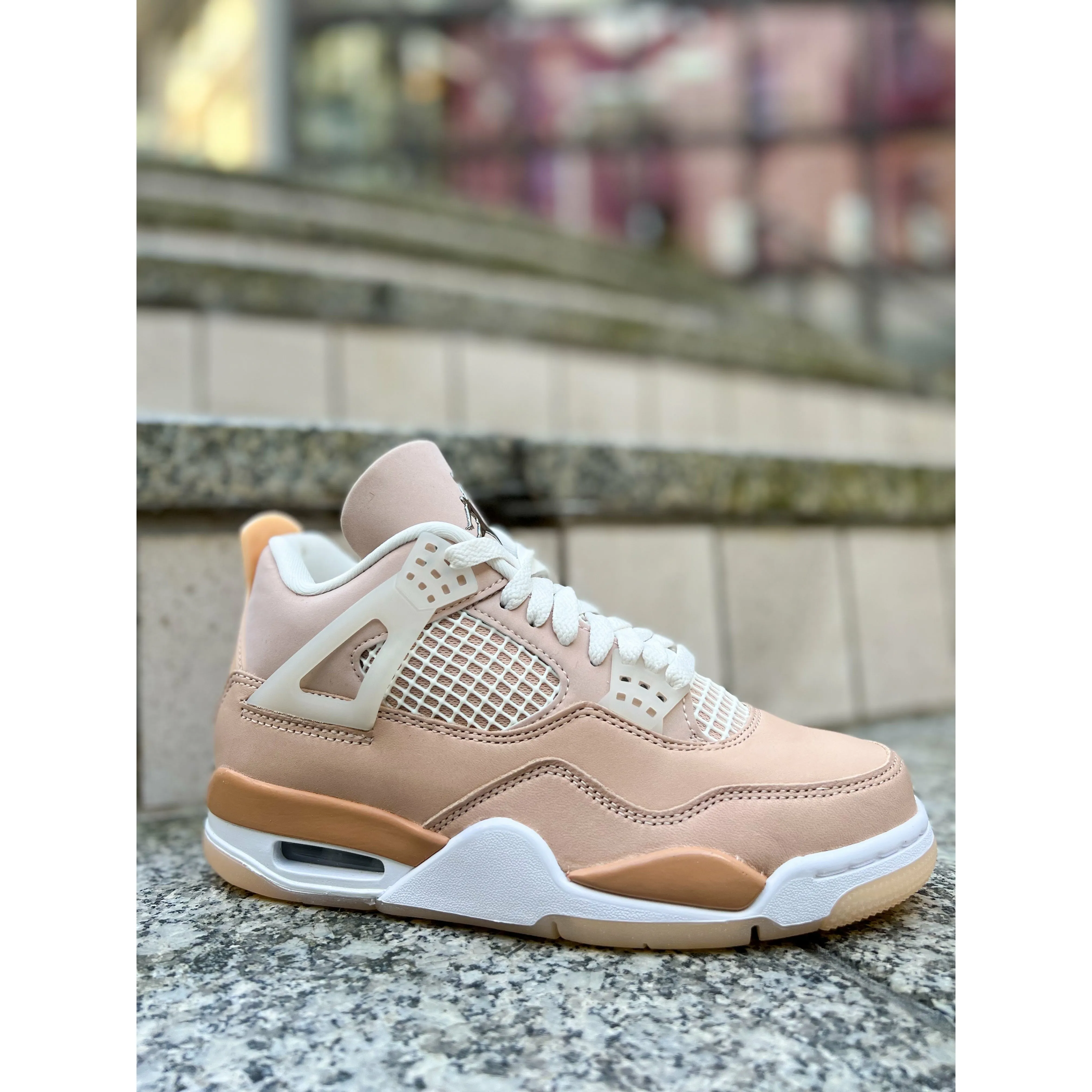 Jordan 4 Retro Shimmer (W) running in a rainforest area shoes